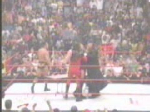 Undertaker and Kane chokeslam HHH through a table