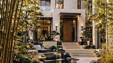 Stunning modern luxury villa featuring lush Japanese garden and waterfall.