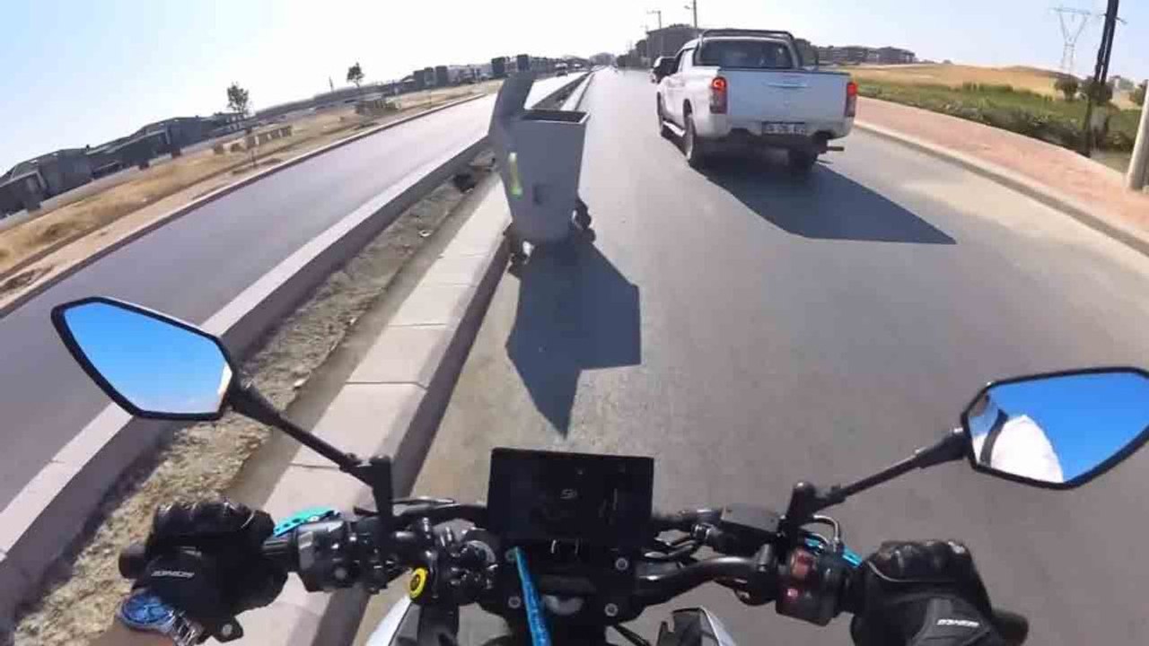 Motorcyclist hits garbage container while overtaking, and incident is caught on camera
