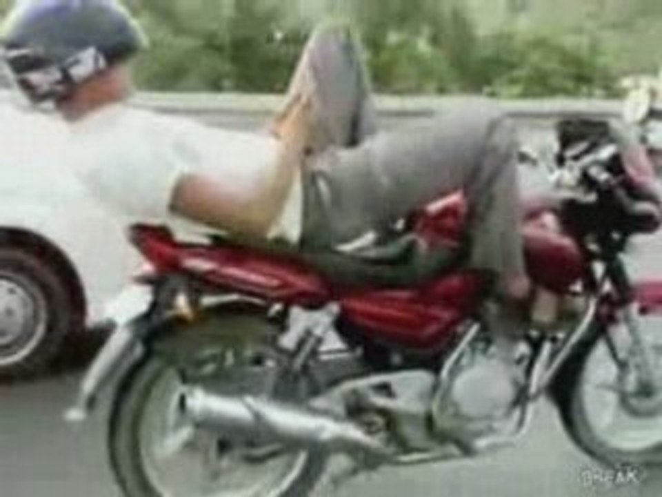Guy Lays Down To Text On Motorcycle