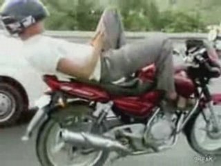 Guy Lays Down To Text On Motorcycle