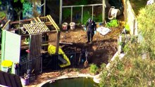Two charged after body found in Queensland backyard