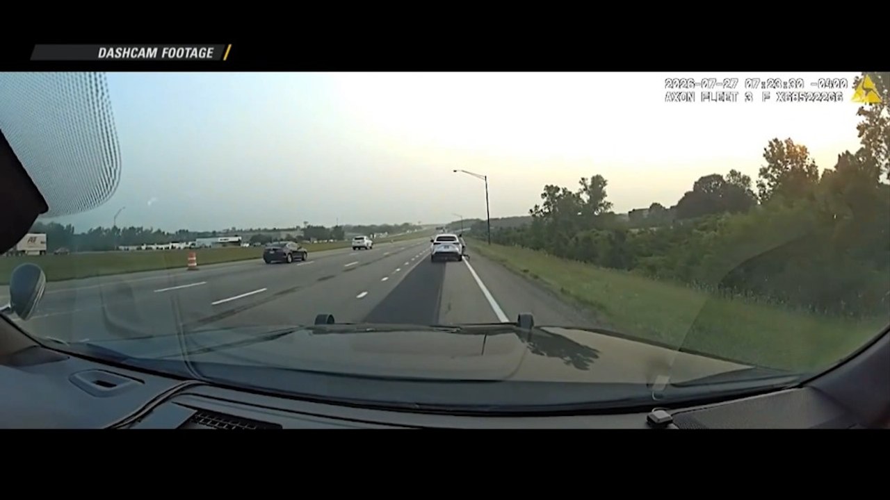 Miami Township Suspect Clings to Car Hood Durin...
