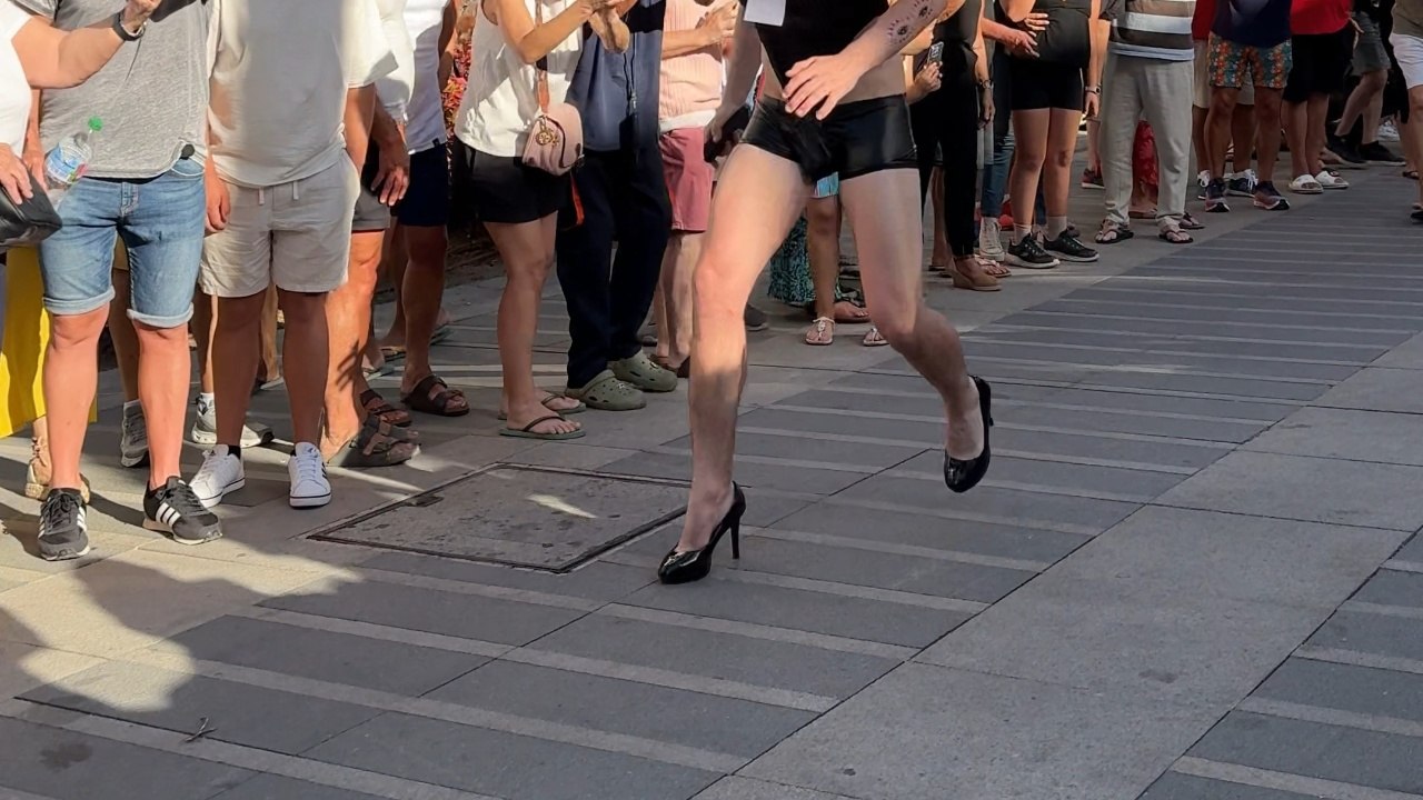 Runners Sprint Down A Street Wearing High Heels In Torremolinos