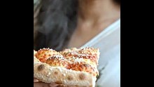 Pirya_biting_deep-dish_pizza