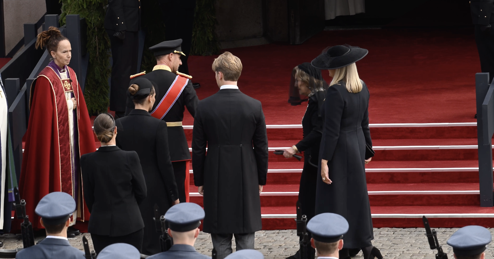 King Haakon reaches for grieving mother Queen Sonja's hand in emotional moment