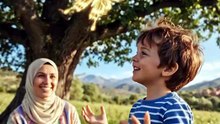 The mother looks at her son and smiles because he is playing.