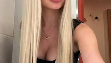 bikini model checking herself in a mirror
