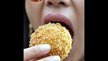 Pirya_biting_fried_arancini_rice_ball
