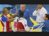 Cuba's Angel Valodia Matos, left, kicks match referee
