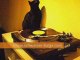 Black cat scratching at a turntable