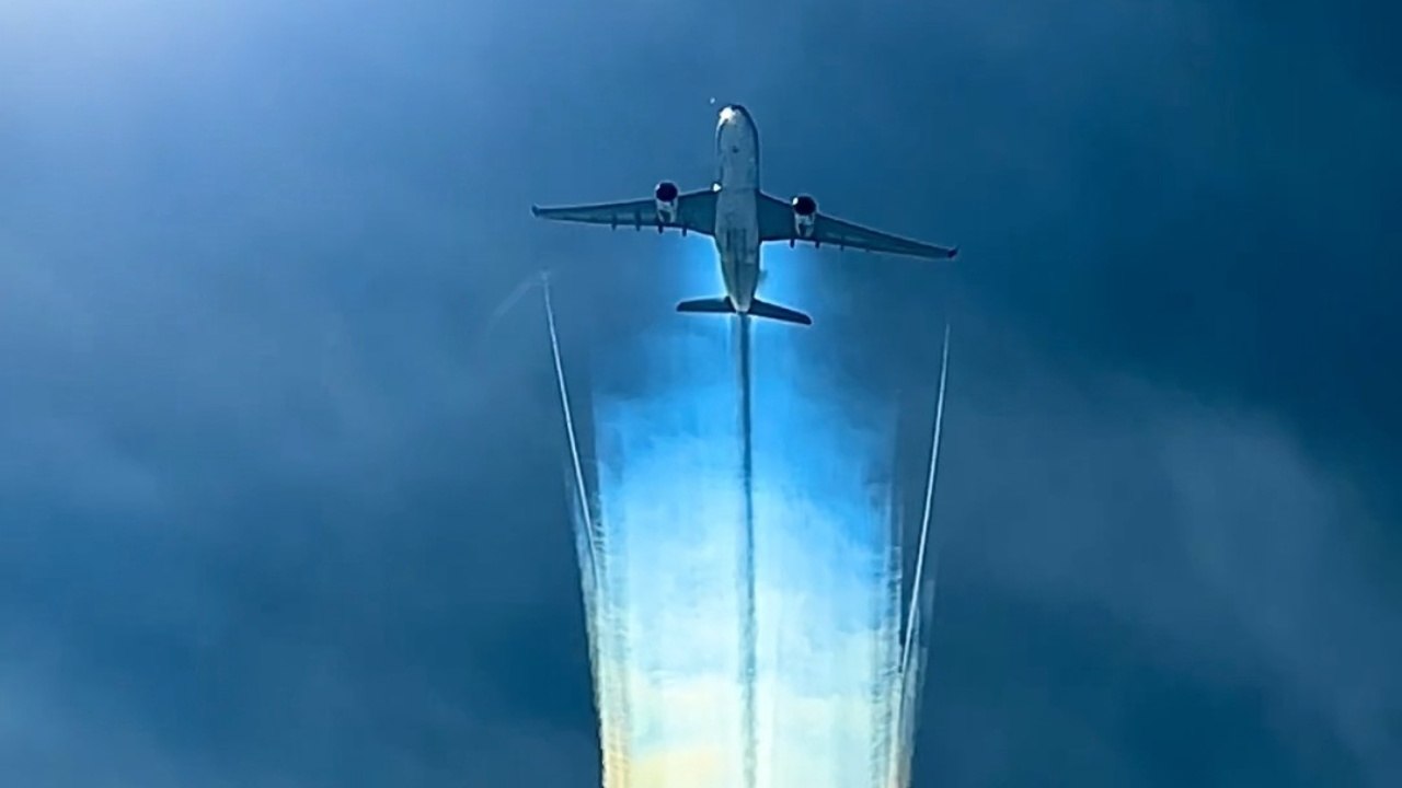 Aircraft Soars Through Sky And Leaves Behind A Sunlit Trail