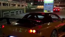 The Legendary Mazda RX-7 FD3S VeilSide Fortune Model inspired by Fast & Furious Tokyo Drift - Han's Car.  Spotted at night in Kobe, Japan near Mosaic. This orange and black JDM icon with custom body kit and deep dish chrome rims is a dream car.  #rx7 #maz