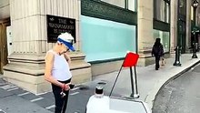 Woman Blocks Delivery Robot on Busy City Sidewalk