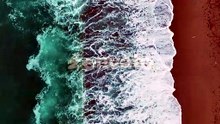 Aerial View of Waves Crashing on Sandy Beach