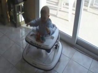 Alexis debout dans son trotteur