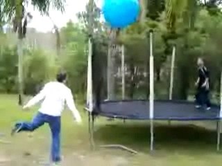Kid on Trampoline Gets Whacked by Big Ball