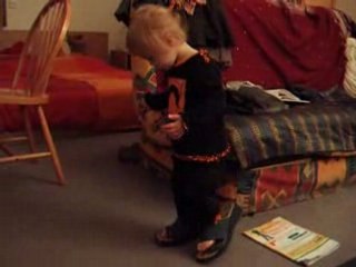 Célia marche avec les chaussures de maman