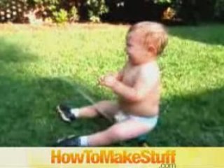 Baby Playing With The Sprinkler