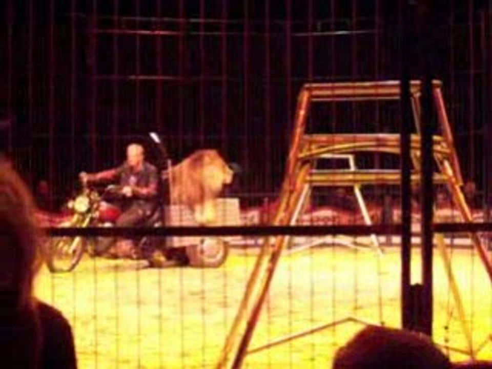 karl peters en moto avec un lion