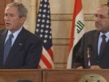 George Bush dodges 'goodbye kiss' shoe-throwing