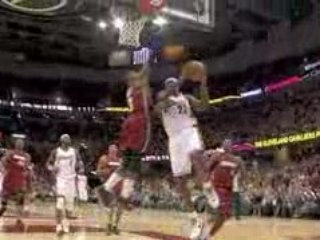 LeBron James goes up and under on the break