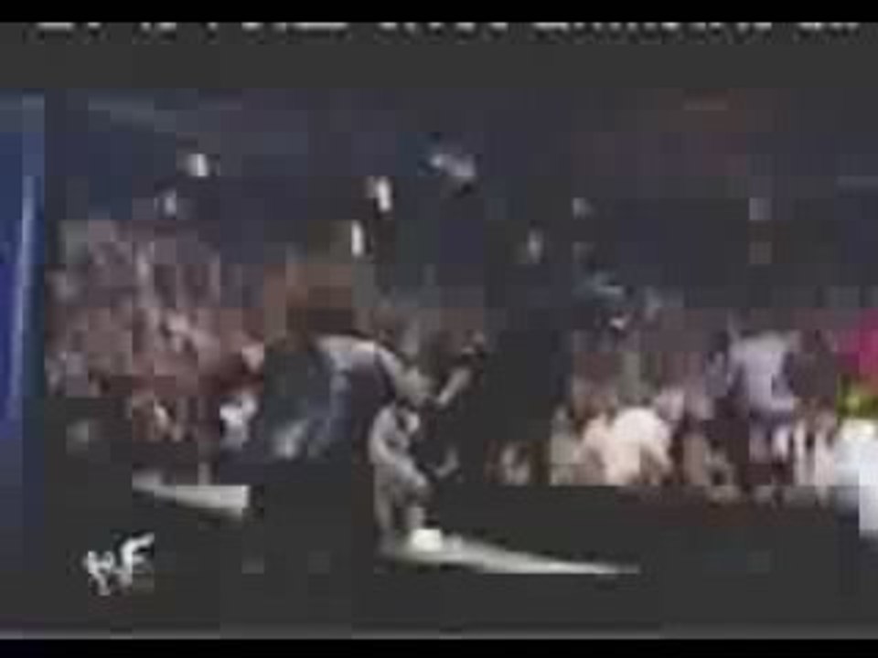 Undertaker chokeslams Shane Mcmahon through announcers table