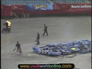 Man on a bike performs stunts while being lit on fire.