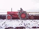 Massive tractors ploughing