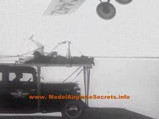 Stunt Plane drops man onto moving car