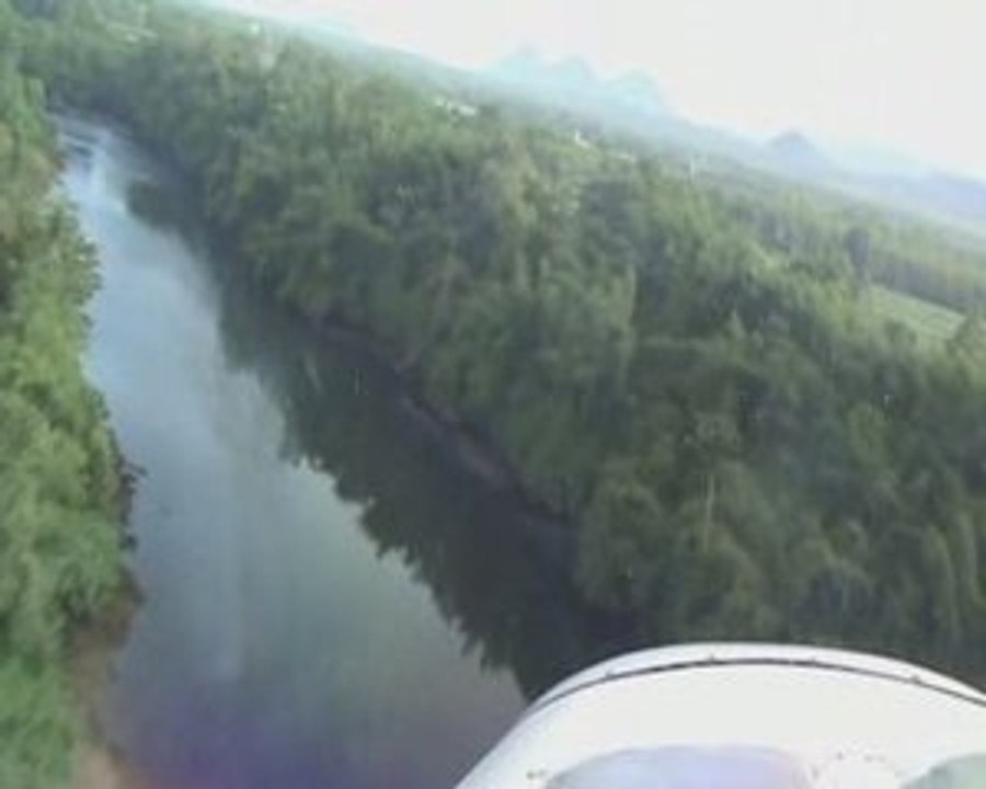 Sport aircraft flying along a winding river