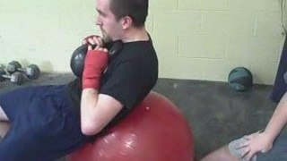 Loaded Swiss Ball Crunch Abdominal Exercise.